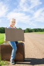 Girl with suitcase standing about road Royalty Free Stock Photo