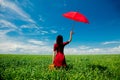 Girl with suitcase and umbrella at wheat field Royalty Free Stock Photo