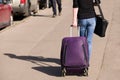 Girl in jeans is on the road with a suitcase Royalty Free Stock Photo