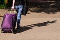 Girl in jeans is on the road with a suitcase Royalty Free Stock Photo