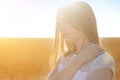 Girl in summer yellow field over sun