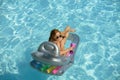 Girl on summertime vacation. Woman swimmsuit. Summertime female on inflatable mattress.