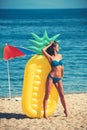 Girl sunbathing on beach with air mattress. girl in swimsuit on sunny beach. Royalty Free Stock Photo