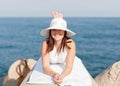 Girl sunbathing on breakwater Royalty Free Stock Photo