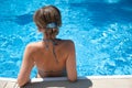 Girl sunbathing by the pool