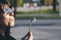 Girl with sunglases blowing a dandelion