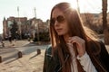 Girl in sunglasses on the background of sunset and city bustle Royalty Free Stock Photo