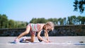 a girl in sunglasses, draws drawings with colored crayons on the asphalt, street tiles. A hot summer day. Royalty Free Stock Photo