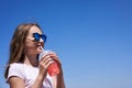 Girl in sunglasses drinking cold lemonade Royalty Free Stock Photo