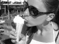 Girl in sunglasses eats ice cream