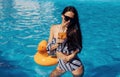 Girl in sunglasses have fun and rest in swimming pool at daytime Royalty Free Stock Photo