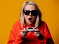 Girl in sunglasses keen plays with a joystick Royalty Free Stock Photo