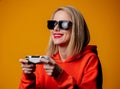 Girl in sunglasses keen plays with a joystick Royalty Free Stock Photo