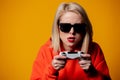 Girl in sunglasses keen plays with a joystick Royalty Free Stock Photo