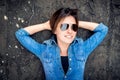 Girl with sunglasses laughing and smiling, hanging out on roof of building. Young active lifestyle people concept