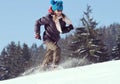 Girl in sunglasses running up a snowy hill Royalty Free Stock Photo