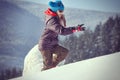 The girl in sunglasses runs up a snowy hill Royalty Free Stock Photo