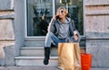 Girl in sunglasses are sitting in a portal with shopping bags Royalty Free Stock Photo