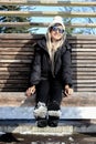 Girl with Sunglasses in winter clothes and boots with snow Royalty Free Stock Photo