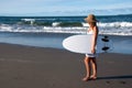 Girl in sunhat with surfboard