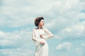 Girl on sunny blue sky background in summer. Beauty and fashion look in vintage style. Makeup on young face. Fashion Royalty Free Stock Photo