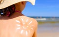 Girl with suntan lotion at the beach in form of the sun Royalty Free Stock Photo