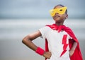 Girl superhero against blurry beach