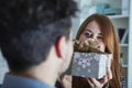 Girl suprise her boyfriend with christmas gift Royalty Free Stock Photo