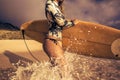 Girl with surfboard In Splashing Wave on a beach