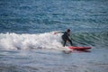 Girl surfing in the waves of the Atlantic ocean Tenerife, Spain Royalty Free Stock Photo
