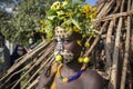 Girl from the Suri tribe poses for a photo with a traditionally painted face. Ethiopia