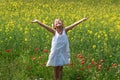 Girl surrounded by rapeseed flowers