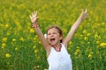 Girl surrounded by rapeseed flowers