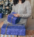 Girl in a sweater near the Christmas tree with a gift, Christmas, New Year Royalty Free Stock Photo