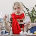 The girl in the sweater is sick and holds a mug with a hot drink. Colds and flu. The patient caught a cold, feeling sick.