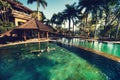 Girl swimming in infinity pool at luxurious resort, hotel. Portrait of woman going for a swim on exotical island Royalty Free Stock Photo