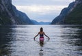 Girl swimming in the Lysefjord fjord from the village of Lysebotn. Royalty Free Stock Photo