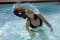 Girl in a swimming pool throwing wet hair Royalty Free Stock Photo