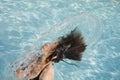 Girl in a swimming pool throwing wet hair Royalty Free Stock Photo