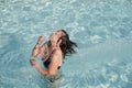 Girl in a swimming pool throwing wet hair Royalty Free Stock Photo