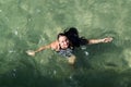 Girl swimming in the stripped dress