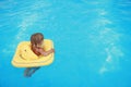 Girl swims in a pool with a circle