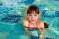 Girl swims in the pool.