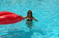 Girl in the pool with a red mattress in the form of lips