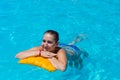 Girl swims in the pool on sunny day
