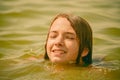 A girl swims in the river. Close up of young beautiful girl in water Royalty Free Stock Photo