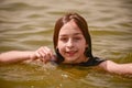 A girl swims in the river. Close up of young beautiful girl in water Royalty Free Stock Photo