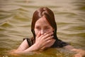 A girl swims in the river. Close up of young beautiful girl in water Royalty Free Stock Photo