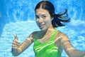 Girl swims in swimming pool underwater, happy active teenager dives and has fun under water, kid fitness on family vacation Royalty Free Stock Photo