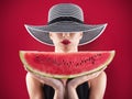 Girl in swimsuit with watermelon in hand and red background Royalty Free Stock Photo